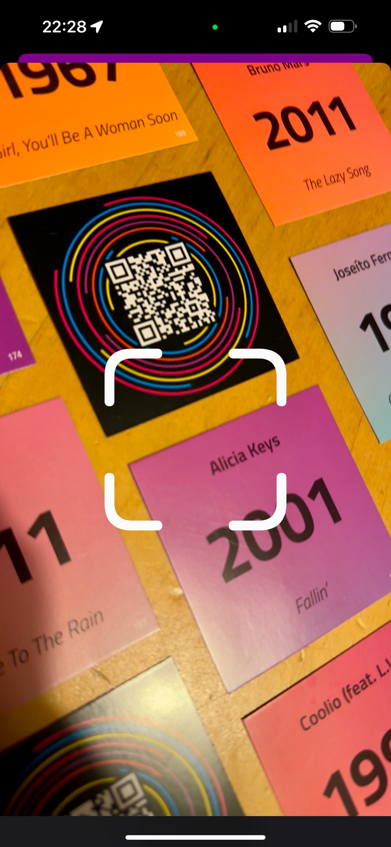 Beatster QR scanner pointed at Hitster cards on a cork board